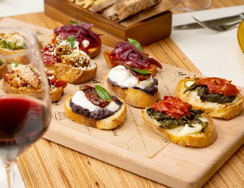 Catania: Volcanic Wine Tasting in a Metropolitan Market - Four glasses, each with a Sicilian bite