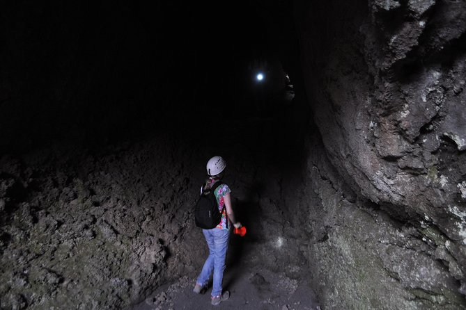 Etna Sunset Experience with aperitif - Entering a volcanic cave with helmets and torches