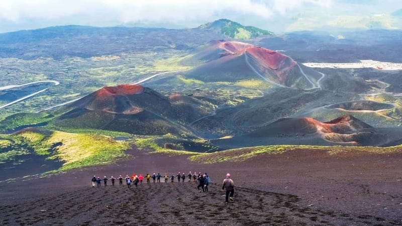 Mount Etna: Trek to 3000m with cable car and jeep - Walking across black sand toward Barbagallo crater