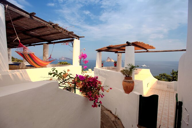 Salina, Panarea and Stromboli from Cefalu, Via Capo D'Orlando - Salina: green hills, capers, and Il Postino