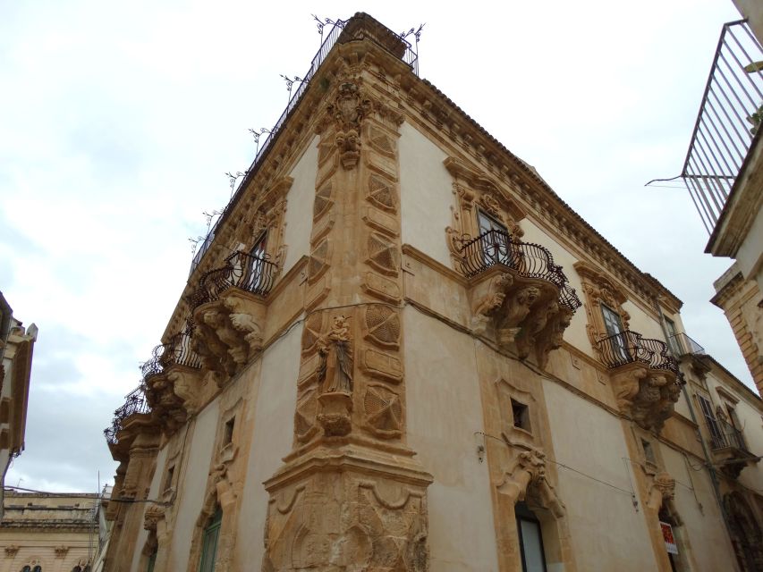 Scicli: Guided Walking Tour in Baroque City Center - Views of the old river and local shops