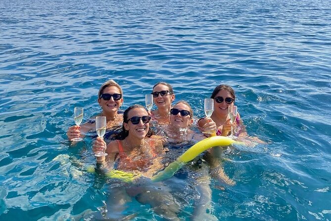 Sicilian wine tasting on the boat in Taormina - Baia delle Sirene and shallow water