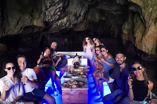 Syracuse Aperitif boat at Sunset island and sea caves - Coral Cave and the red color inside the rock