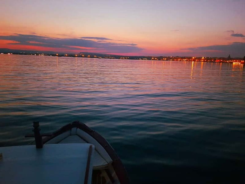 Syracuse: Sunset cruise including aperitif and swim stop - Circling Ortigia’s fortifications and old waterfronts